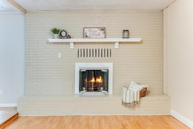 room details with hardwood / wood-style floors and a brick fireplace