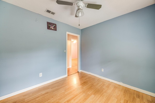 spare room featuring ceiling fan and light hardwood / wood-style flooring