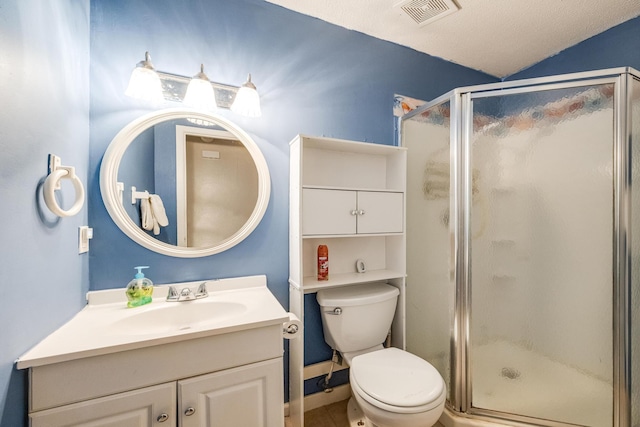 bathroom with vanity, a textured ceiling, toilet, and a shower with shower door