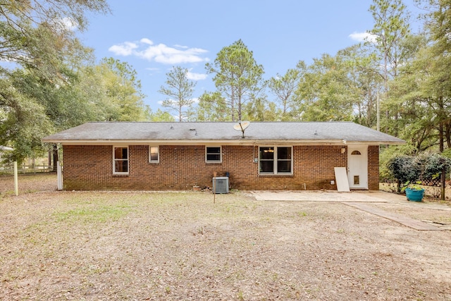 rear view of house featuring central AC unit