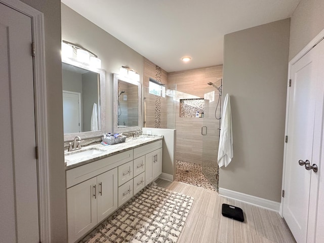 bathroom featuring vanity and a shower with shower door