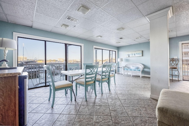 dining space featuring a drop ceiling