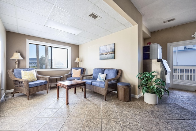 living room with a paneled ceiling