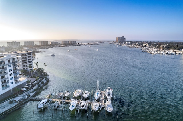 aerial view at dusk featuring a water view