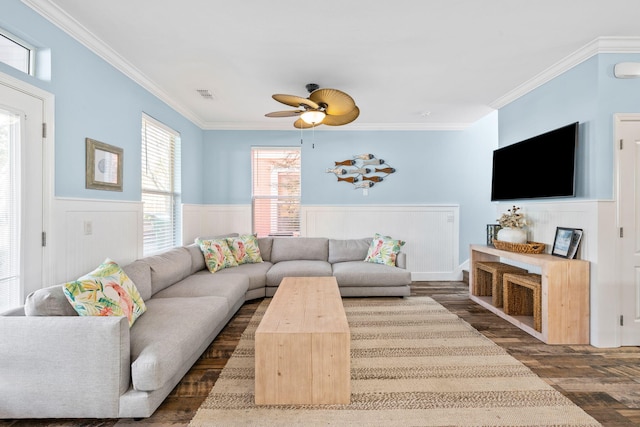 living room with visible vents, a ceiling fan, ornamental molding, wainscoting, and dark wood finished floors