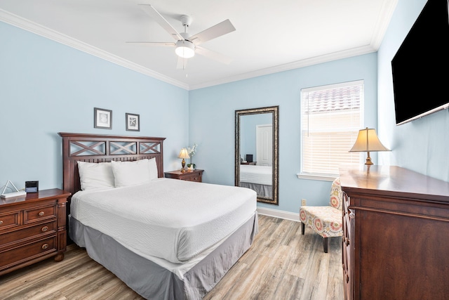 bedroom with light wood finished floors, baseboards, ornamental molding, and a ceiling fan