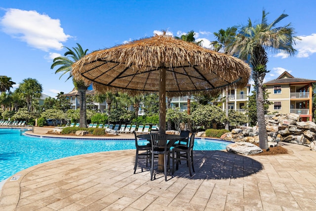 community pool with a patio area