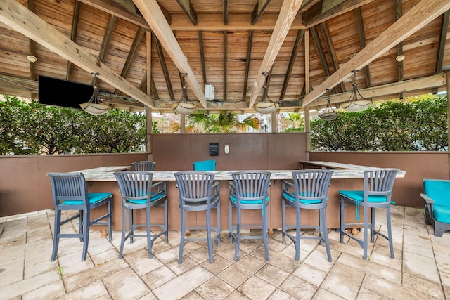 view of patio with outdoor dry bar and a gazebo