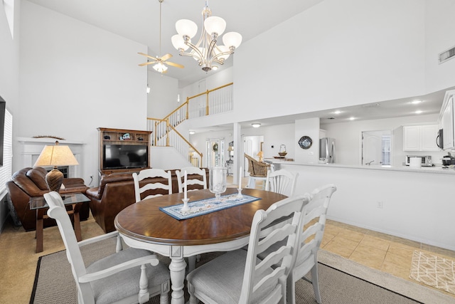 dining space featuring high vaulted ceiling, light tile patterned floors, and an inviting chandelier