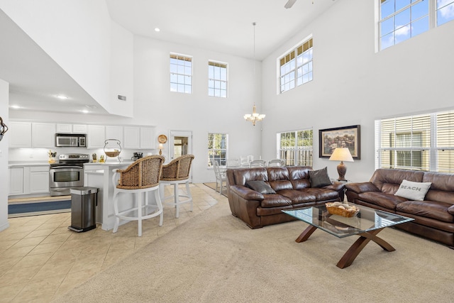 tiled living room with a chandelier and a towering ceiling