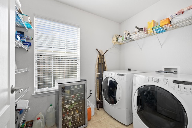 washroom with light tile patterned flooring, independent washer and dryer, and beverage cooler