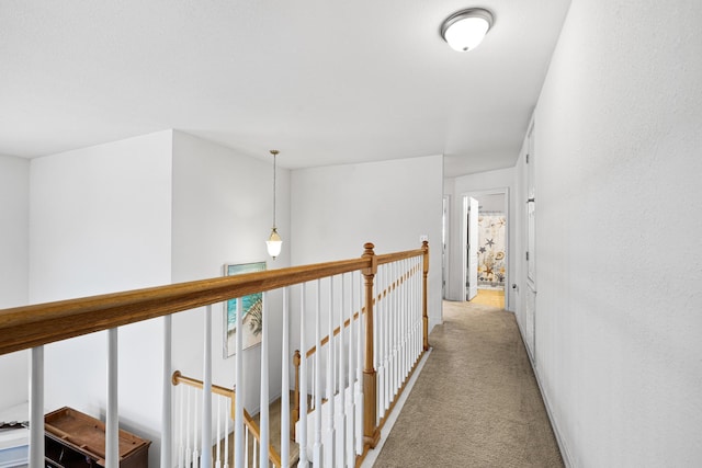 hall featuring light colored carpet