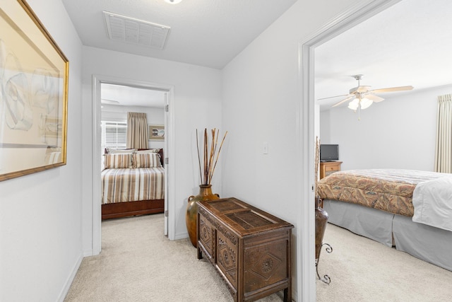 bedroom featuring ceiling fan and light colored carpet