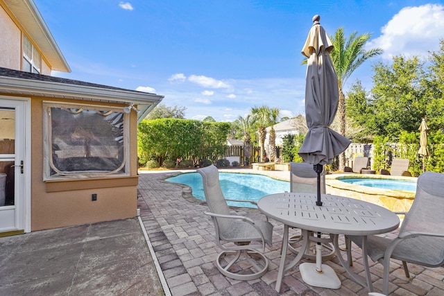 view of swimming pool featuring an in ground hot tub and a patio area