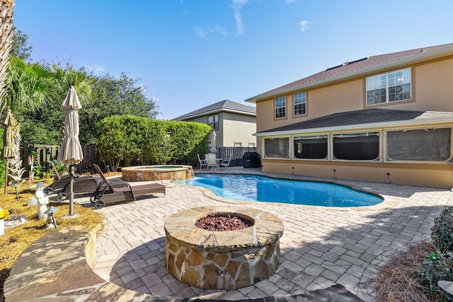 view of pool featuring an in ground hot tub, an outdoor fire pit, and a patio