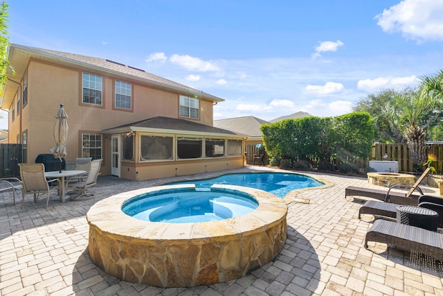 view of swimming pool with a patio area and an in ground hot tub