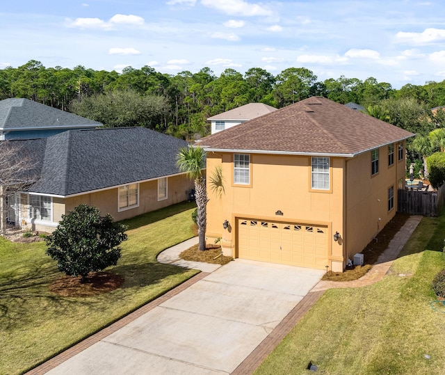 view of front of house featuring a front lawn and a garage