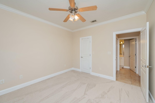 unfurnished bedroom with a closet, light colored carpet, ceiling fan, and ornamental molding