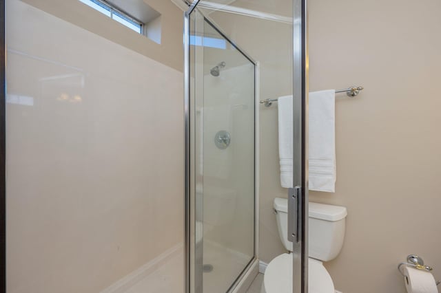 bathroom with an enclosed shower and toilet