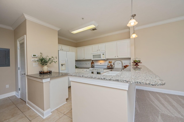 kitchen with sink, white appliances, kitchen peninsula, and hanging light fixtures