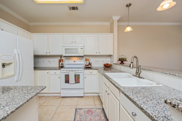 kitchen featuring backsplash, sink, decorative light fixtures, and white appliances