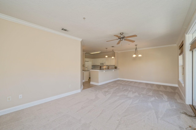 unfurnished living room featuring a textured ceiling, ceiling fan with notable chandelier, ornamental molding, and light carpet