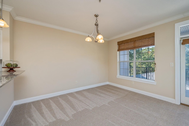 unfurnished dining area with light colored carpet, ornamental molding, and an inviting chandelier