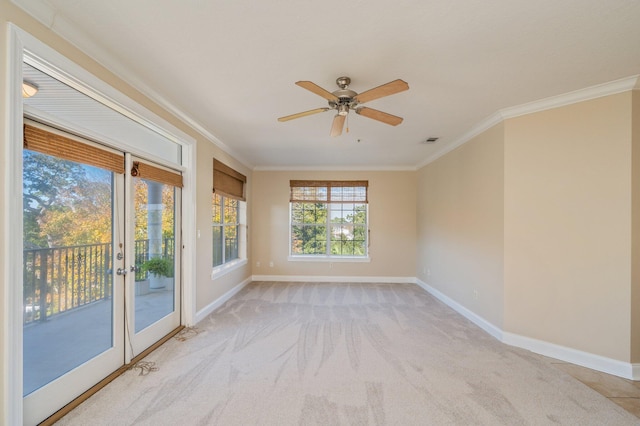 empty room with crown molding, ceiling fan, and light colored carpet