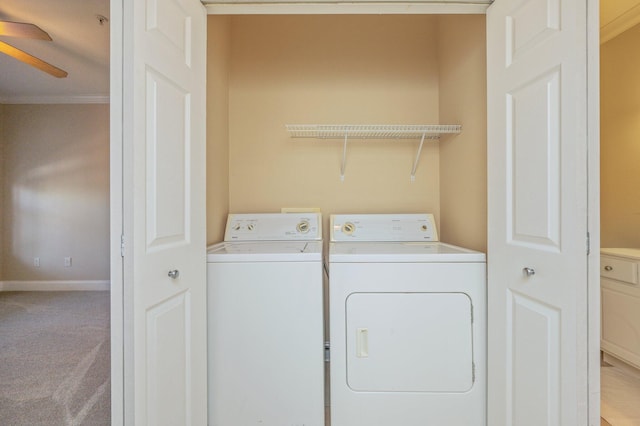 laundry area featuring carpet flooring, ceiling fan, crown molding, and washing machine and clothes dryer