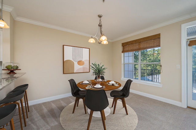 dining room with light colored carpet, ornamental molding, and an inviting chandelier