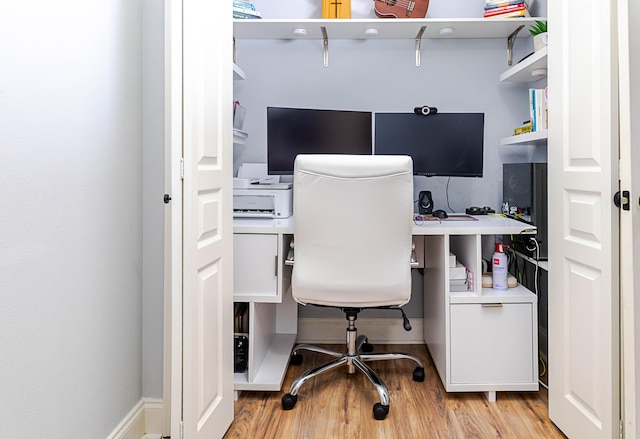 office featuring baseboards and light wood-style floors