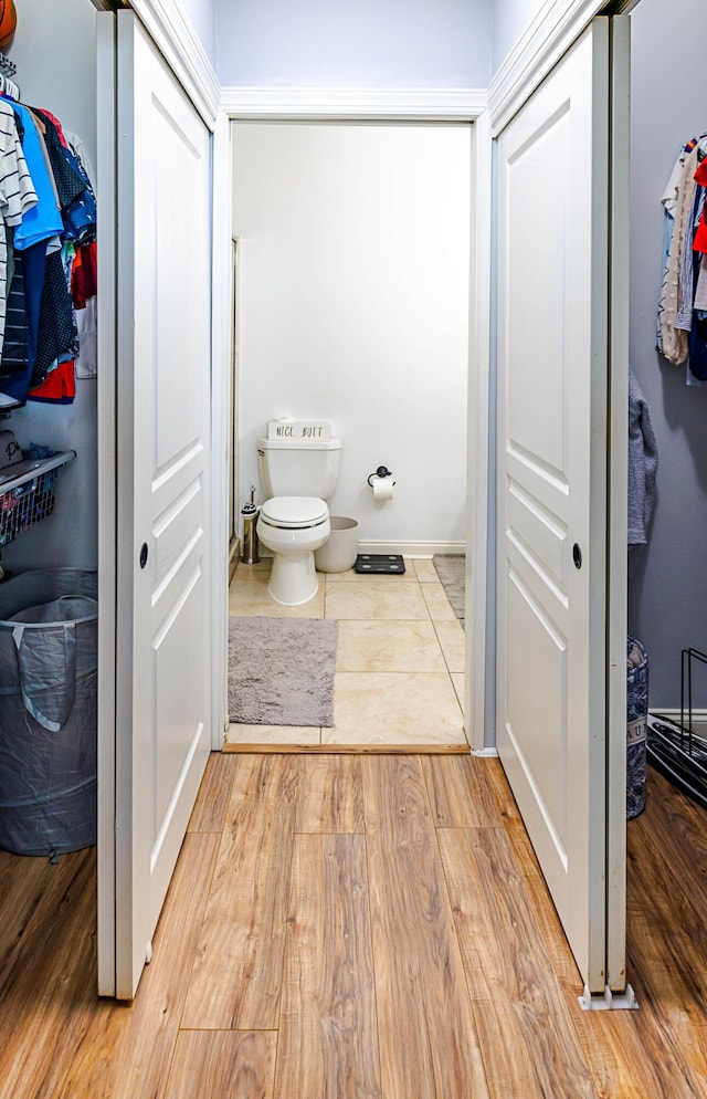 bathroom featuring wood finished floors and toilet