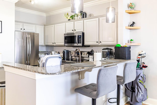 kitchen with a breakfast bar area, open shelves, tasteful backsplash, appliances with stainless steel finishes, and ornamental molding