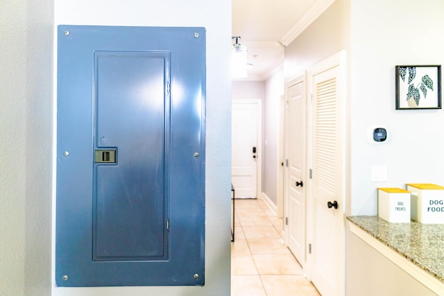 hallway with ornamental molding and light tile patterned flooring