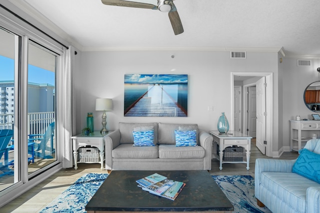 living room featuring ceiling fan, light wood-type flooring, and ornamental molding