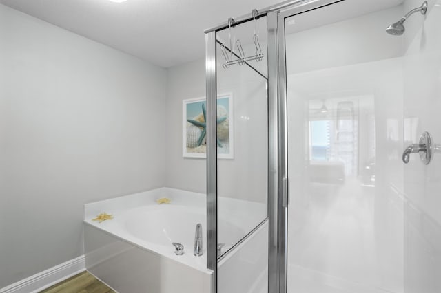 bathroom with separate shower and tub and wood-type flooring