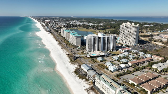 birds eye view of property with a water view and a beach view