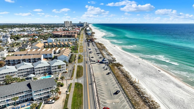 birds eye view of property featuring a water view and a beach view