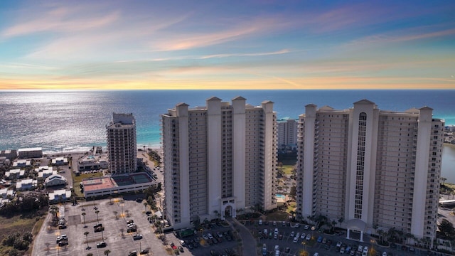 aerial view at dusk featuring a water view