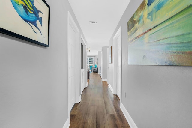 corridor with dark hardwood / wood-style floors