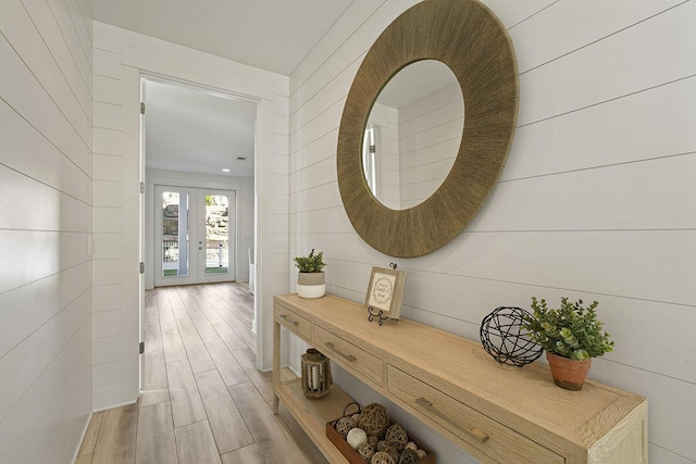 corridor featuring hardwood / wood-style floors and french doors