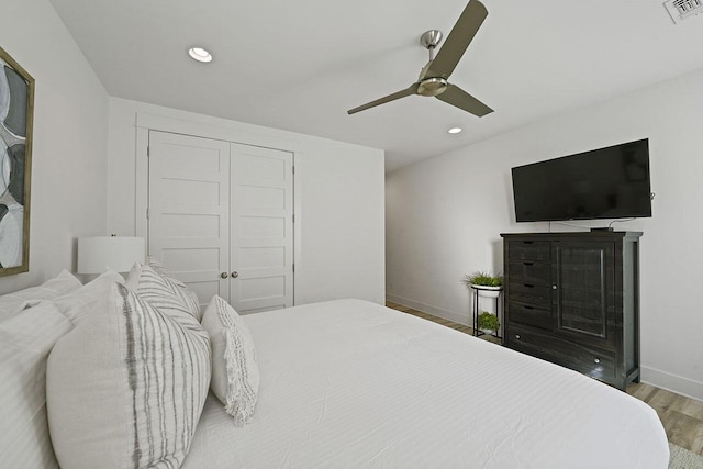 bedroom with a closet, ceiling fan, and hardwood / wood-style floors