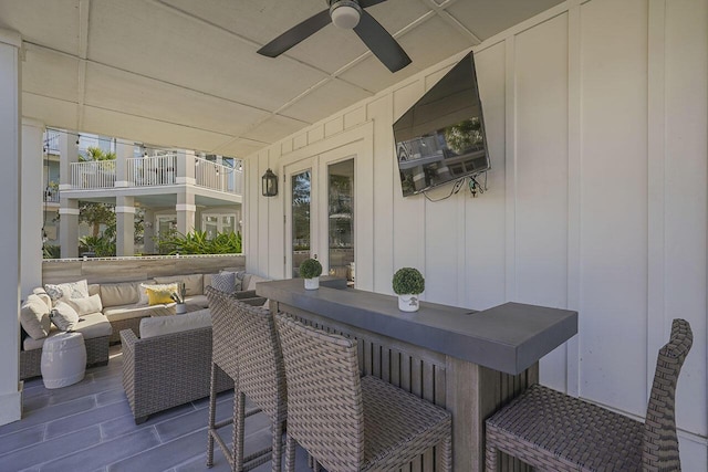 sunroom / solarium featuring ceiling fan