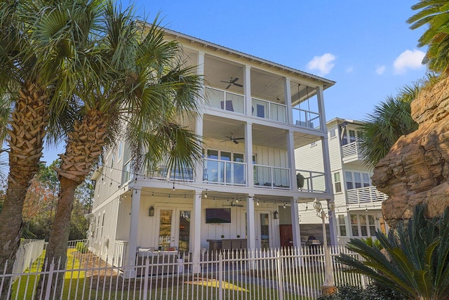 view of front of home with french doors, a balcony, and ceiling fan