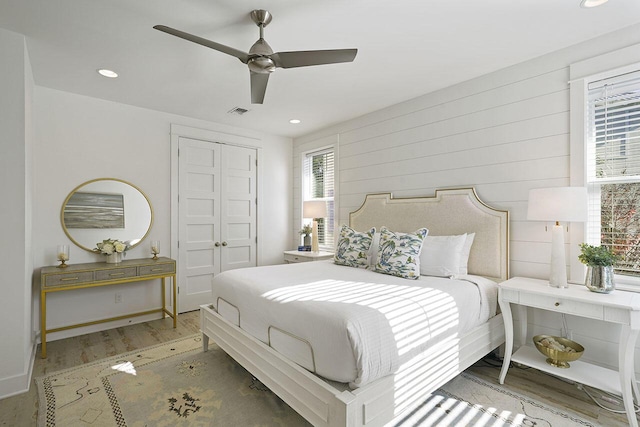 bedroom featuring ceiling fan, a closet, and wood-type flooring