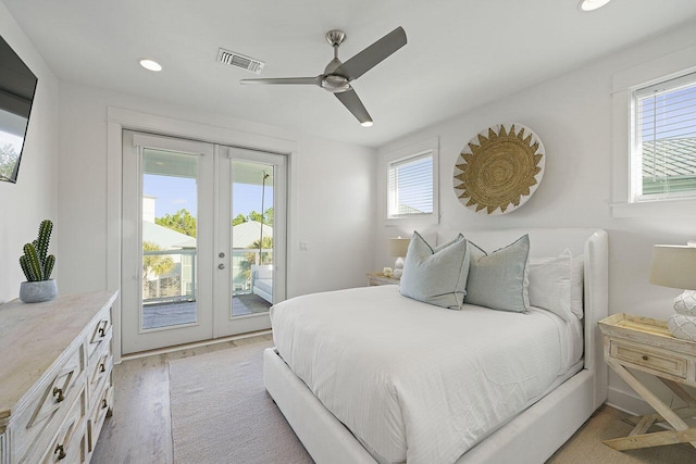 bedroom featuring access to exterior, french doors, light hardwood / wood-style floors, and ceiling fan