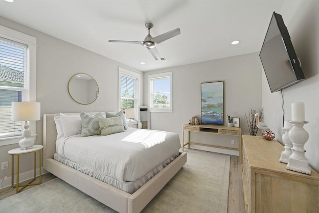 bedroom with ceiling fan and light wood-type flooring