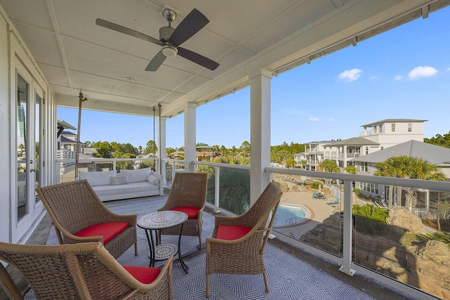 sunroom / solarium featuring a wealth of natural light and ceiling fan