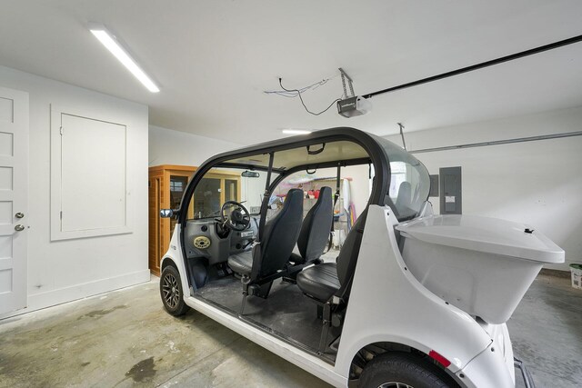 garage with electric panel and a garage door opener