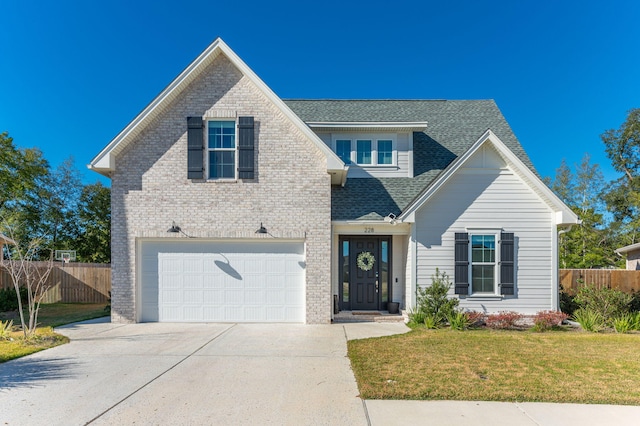 view of front of home featuring a front yard and a garage